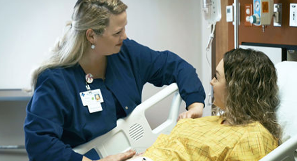 a group of people looking at a laptop
