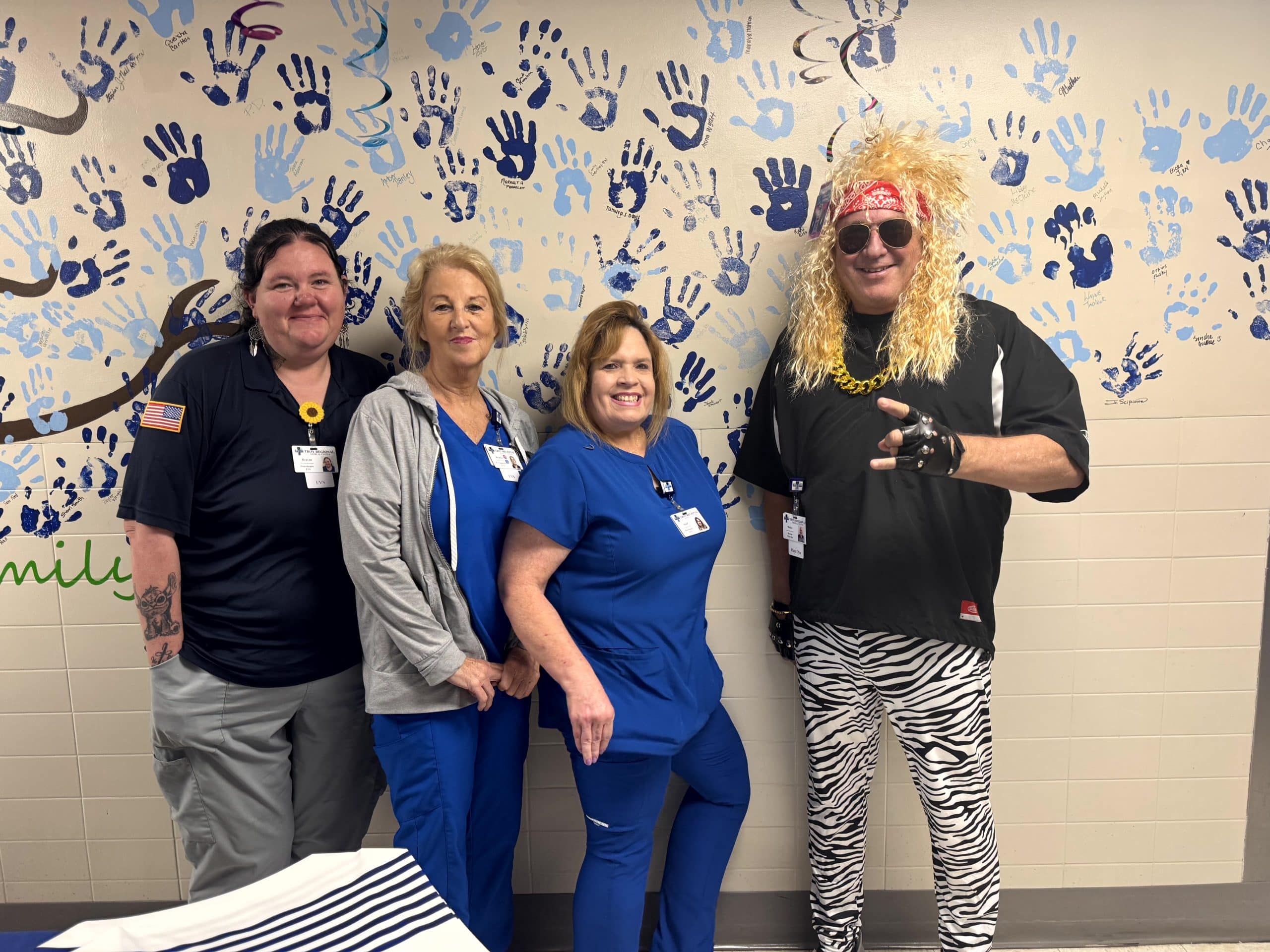 a person standing in front of a group of people posing for the camera